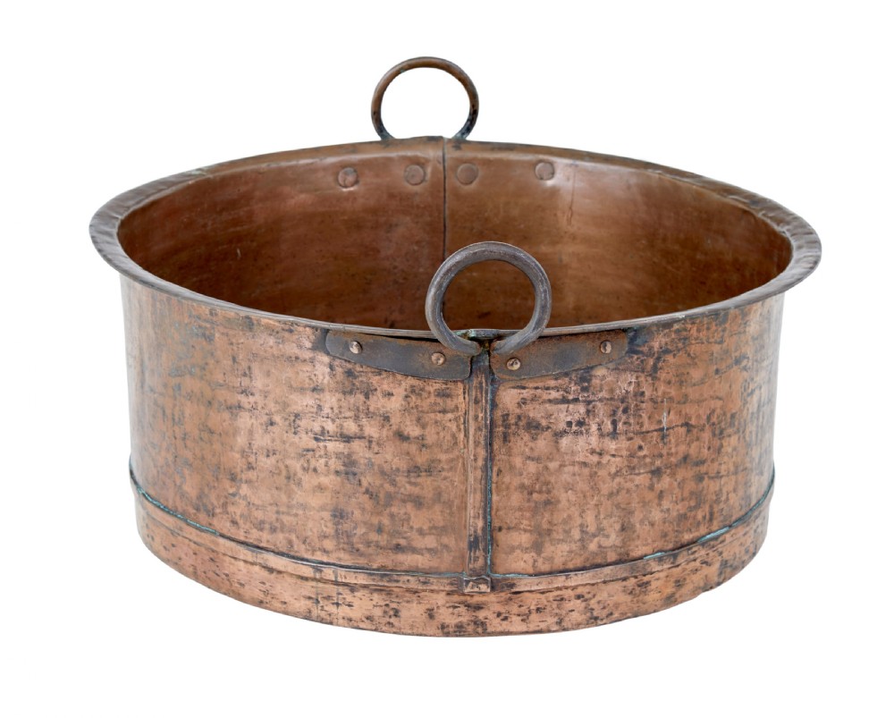 A large round 19th-century hand-hammered copper cooking vessel featuring dual vertical loop handles attached with rivets. View II