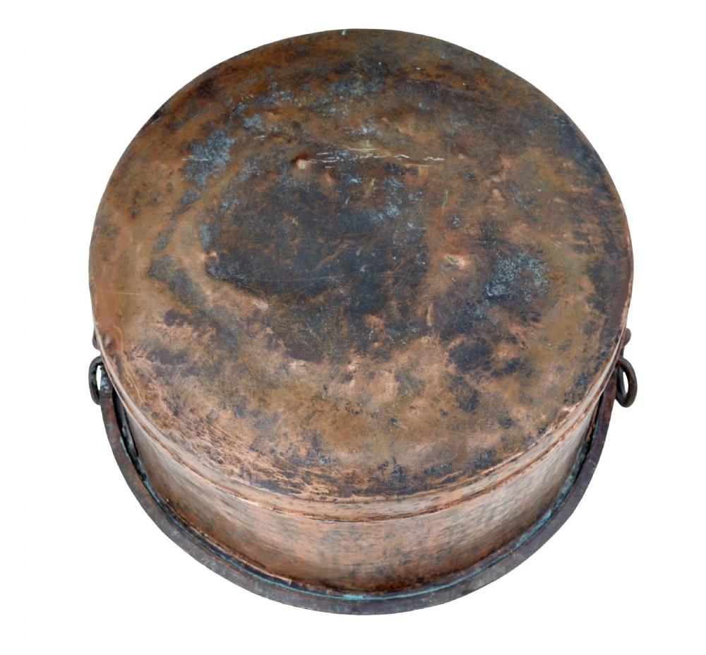 A large round 19th-century hand-hammered copper cooking vessel featuring dual vertical loop handles attached with rivets. View V