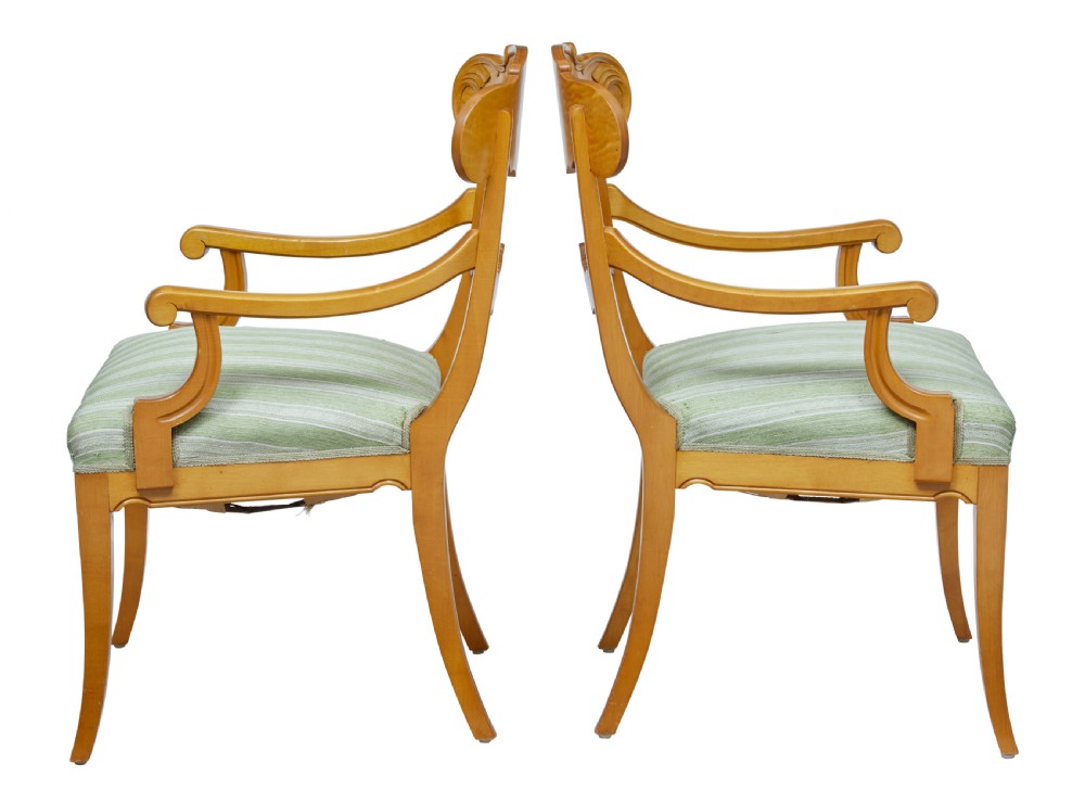 A pair of early 20th-century Swedish birch armchairs featuring carved scroll crests, central relief back rails, and green striped upholstered seats. View II