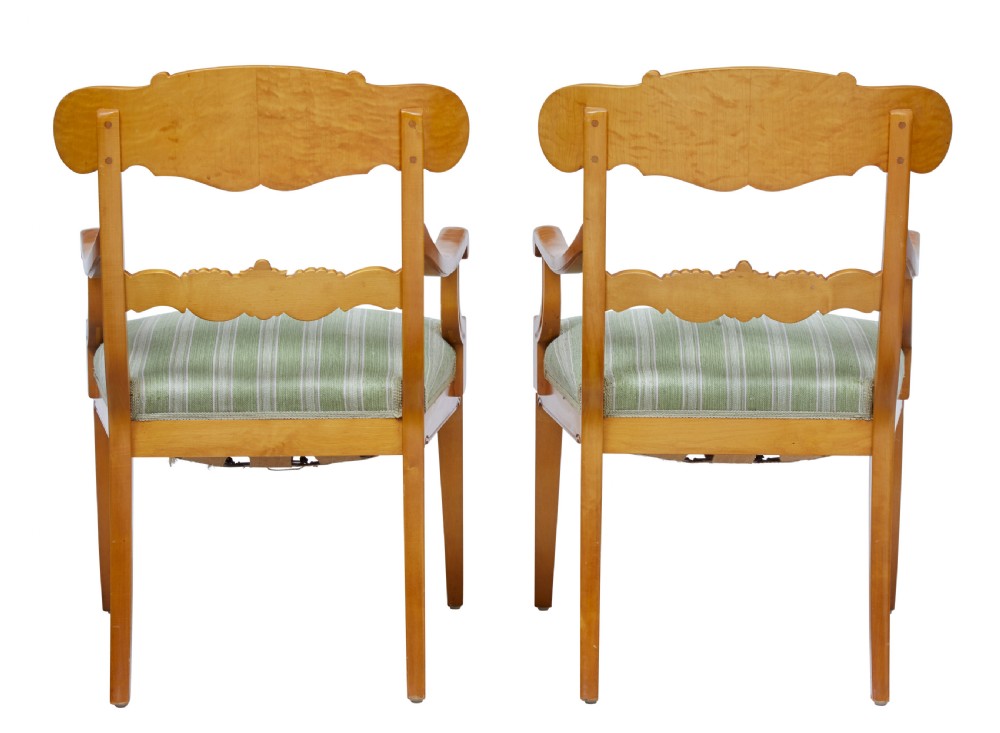 A pair of early 20th-century Swedish birch armchairs featuring carved scroll crests, central relief back rails, and green striped upholstered seats. View III