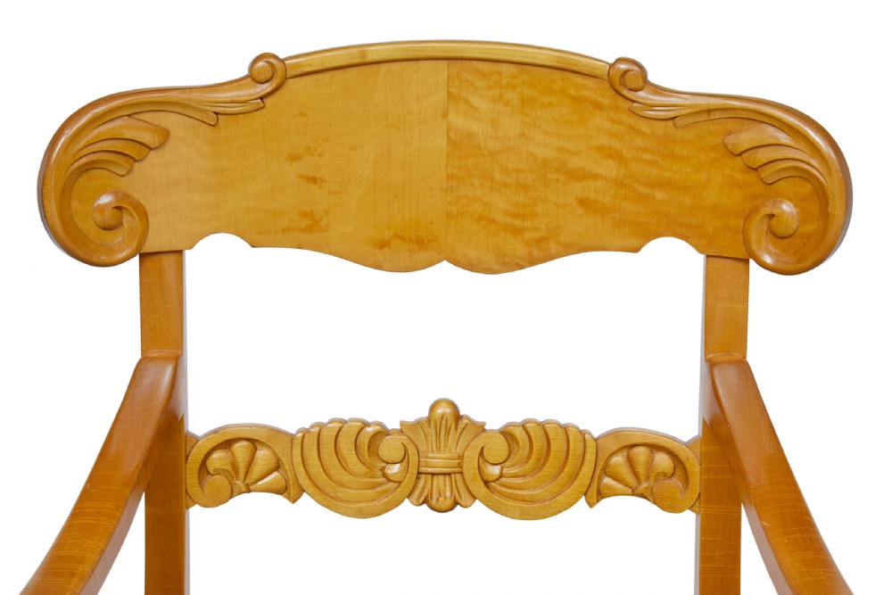 A pair of early 20th-century Swedish birch armchairs featuring carved scroll crests, central relief back rails, and green striped upholstered seats. View IV