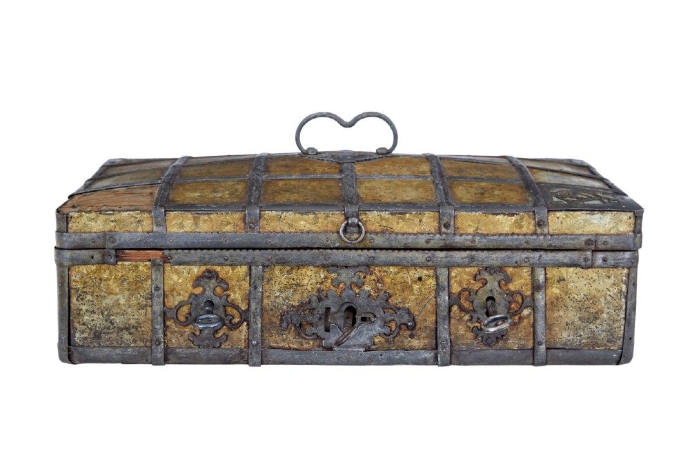 An eighteenth-century Scandinavian metal-bound box featuring an ochre patterned surface, wrought-iron strapping, double keyhole escutcheons with keys, and a top carrying handle.