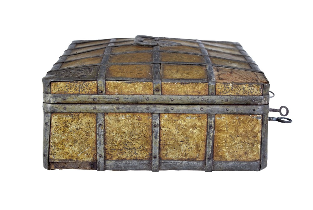 An eighteenth-century Scandinavian metal-bound box featuring an ochre patterned surface, wrought-iron strapping, double keyhole escutcheons with keys, and a top carrying handle. View V