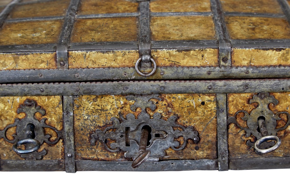 An eighteenth-century Scandinavian metal-bound box featuring an ochre patterned surface, wrought-iron strapping, double keyhole escutcheons with keys, and a top carrying handle. View VI