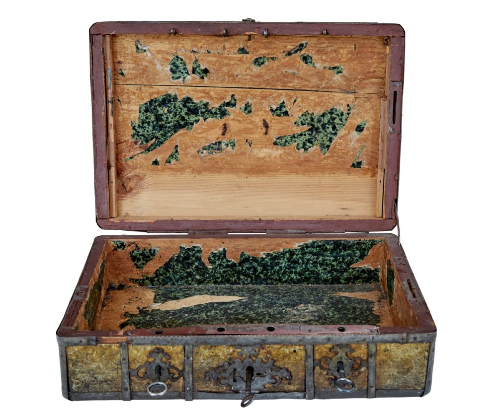 An eighteenth-century Scandinavian metal-bound box featuring an ochre patterned surface, wrought-iron strapping, double keyhole escutcheons with keys, and a top carrying handle. View X
