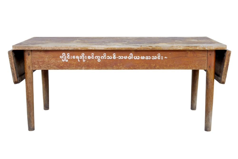 A long 19th-century Burmese teak table with a weathered brown finish and white hand-painted Burmese script across the front frieze. View III