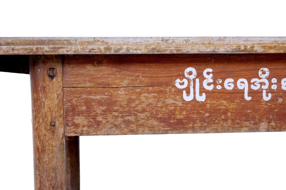 A long 19th-century Burmese teak table with a weathered brown finish and white hand-painted Burmese script across the front frieze. View IX