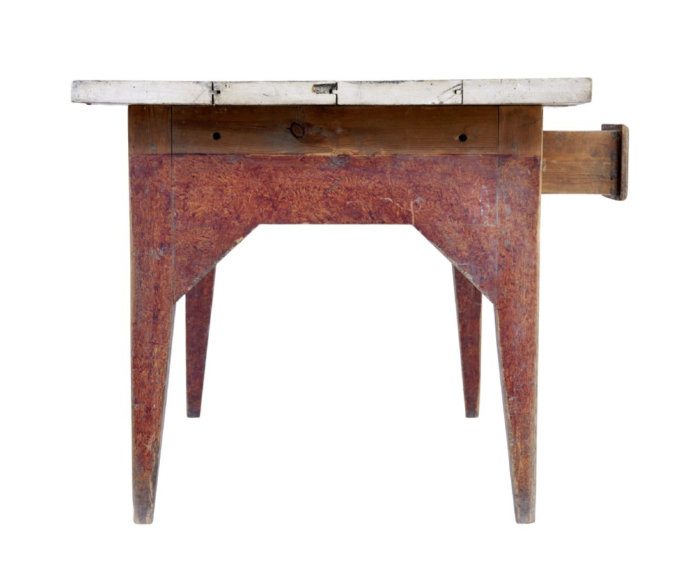 A mid 19th-century rustic pine kitchen table featuring a light wood top, a painted reddish-brown apron, and four tapered square legs. View II