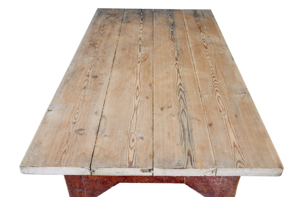 A mid 19th-century rustic pine kitchen table featuring a light wood top, a painted reddish-brown apron, and four tapered square legs. View III