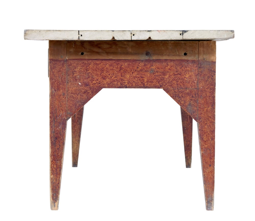 A mid 19th-century rustic pine kitchen table featuring a light wood top, a painted reddish-brown apron, and four tapered square legs. View VIII