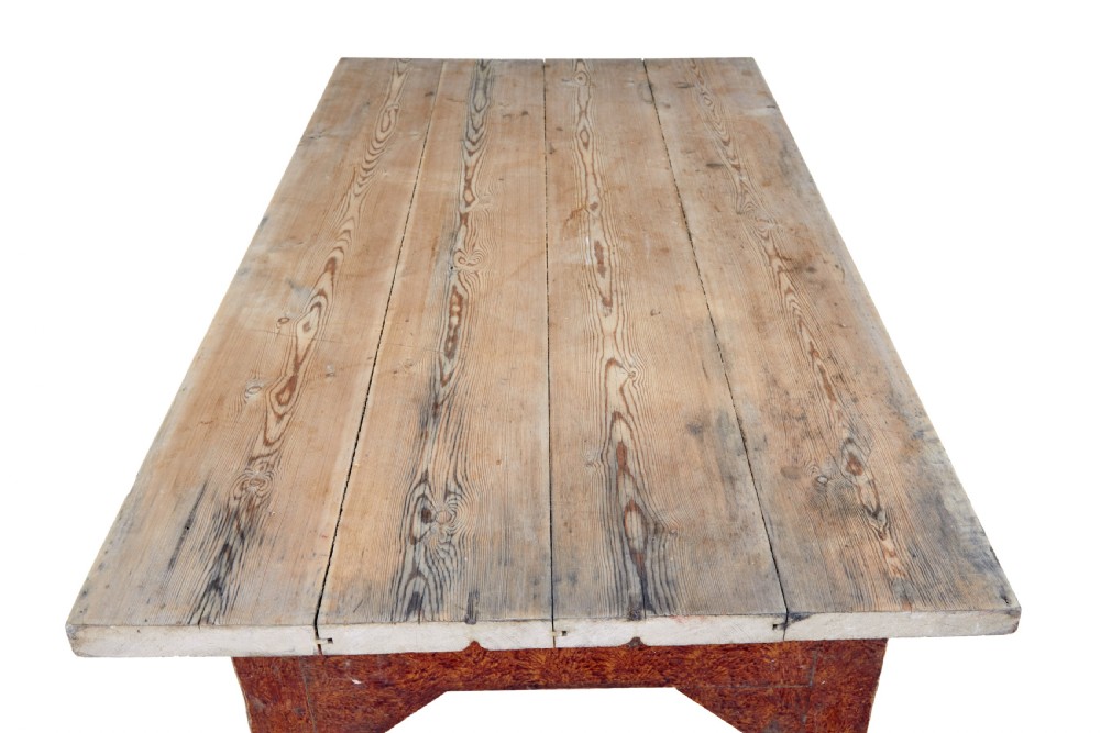 A mid 19th-century rustic pine kitchen table featuring a light wood top, a painted reddish-brown apron, and four tapered square legs. View IX