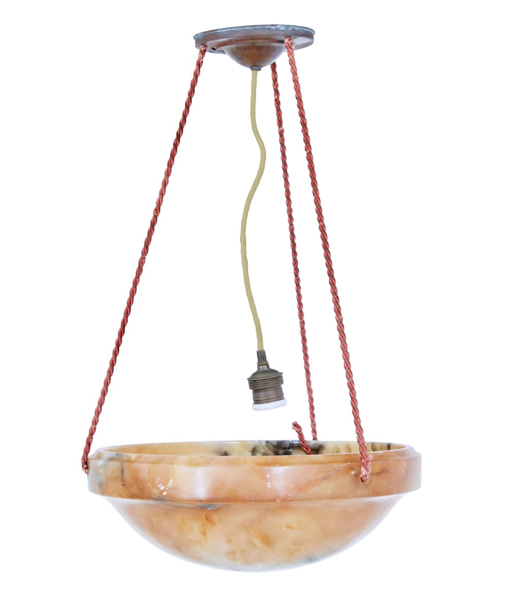 An Art Deco carved alabaster bowl pendant light with natural amber veining suspended by three braided cords from a central brass canopy.