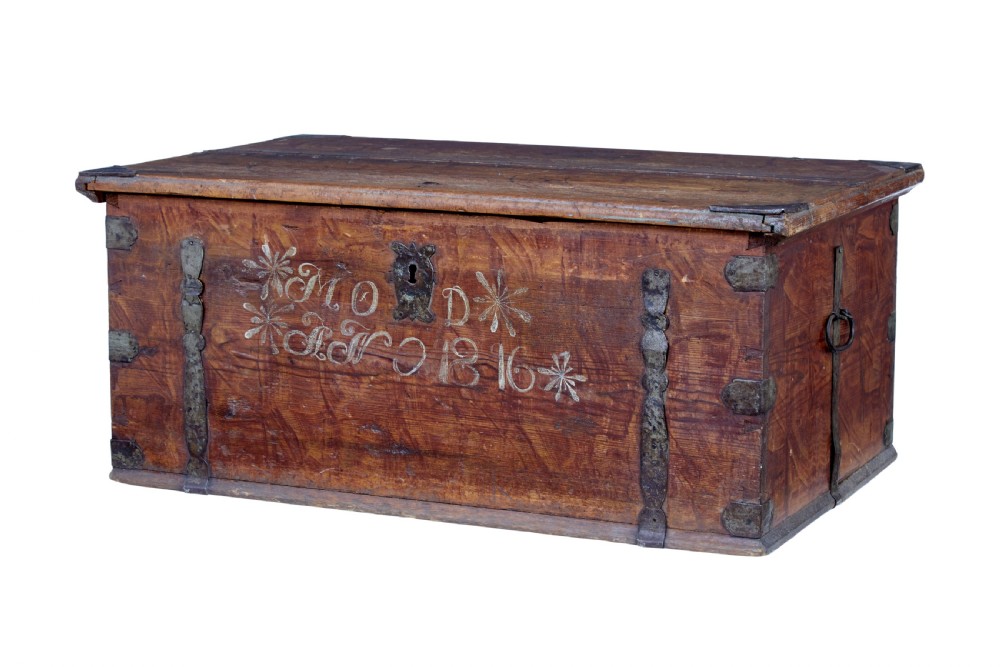 An early 19th-century Swedish pine blanket box featuring white hand-painted initials, the date 1816, star motifs, and hand-forged iron fittings.