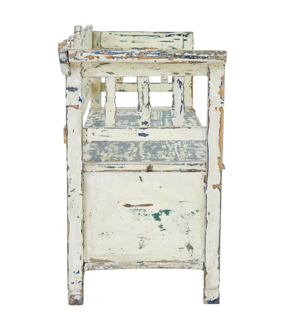 A 19th-century Swedish painted pine storage bench with distressed off-white and blue paint, spindle backrest, and box seat base. View V