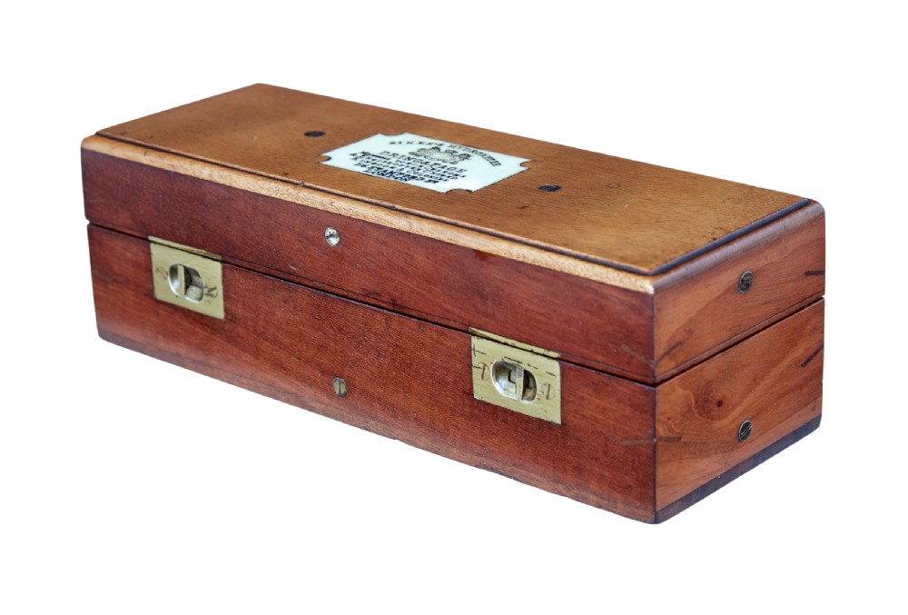 A rectangular Victorian mahogany wooden box with dual brass latches and an inlaid ivory-coloured makers plaque on the top lid.