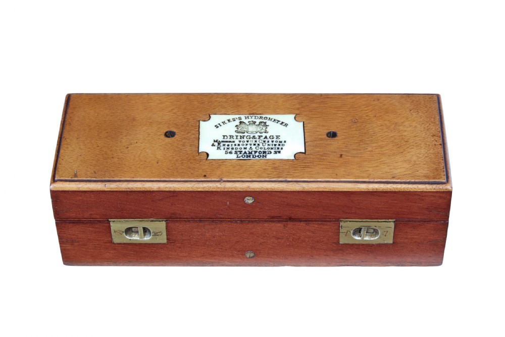 A rectangular Victorian mahogany wooden box with dual brass latches and an inlaid ivory-coloured makers plaque on the top lid. View II