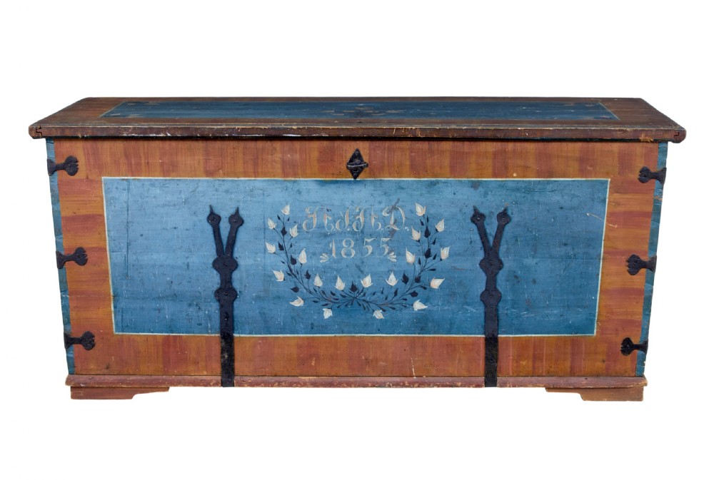 A mid-19th-century Swedish painted wooden coffer featuring blue centre panels decorated with a floral wreath and the date 1855, framed by terracotta borders and black wrought iron straps.