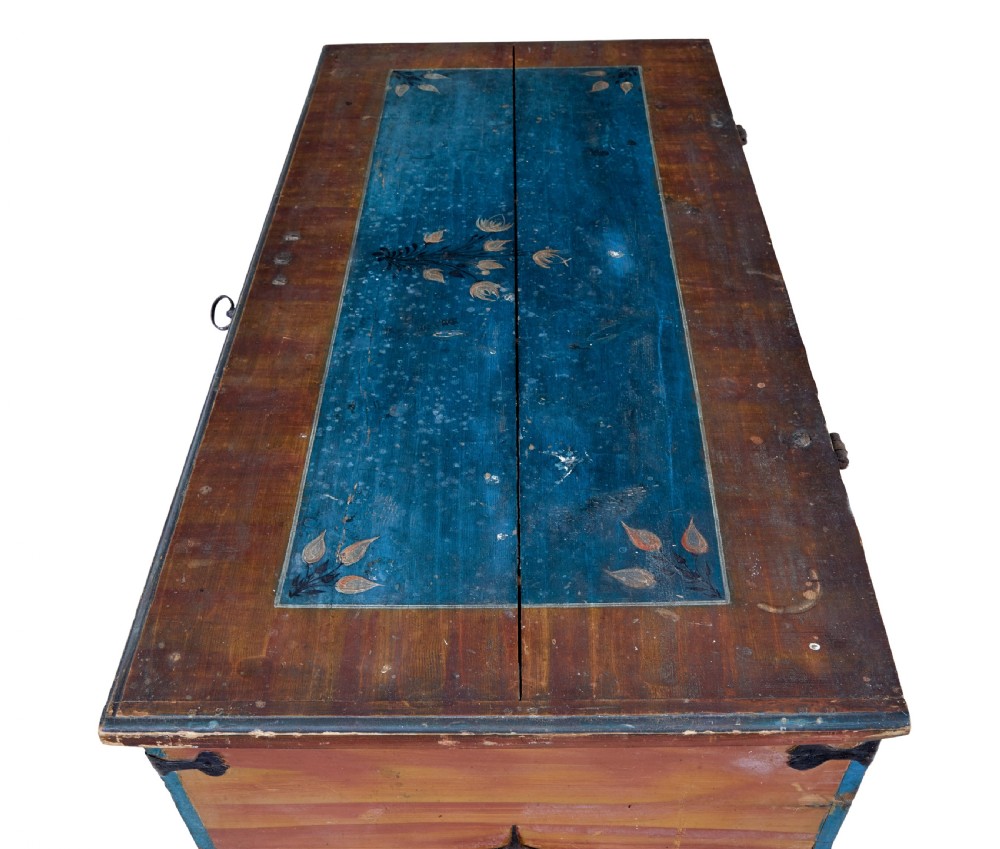 A mid-19th-century Swedish painted wooden coffer featuring blue centre panels decorated with a floral wreath and the date 1855, framed by terracotta borders and black wrought iron straps. View VIII