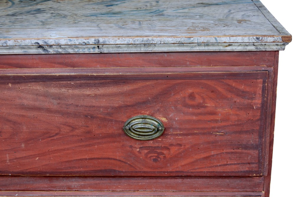 A nineteenth-century Swedish three-drawer chest featuring a reddish-brown faux-grain painted finish and oval brass handles. View VI