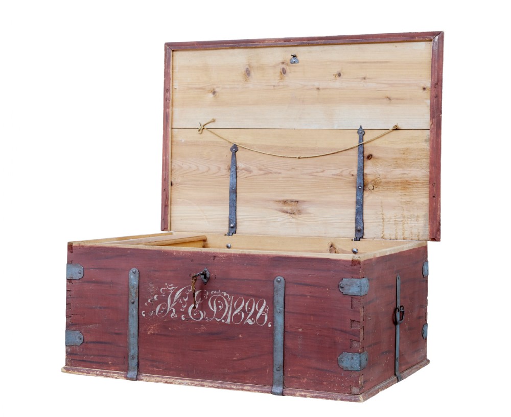 A 19th-century red-painted pine blanket box featuring white hand-painted script dated 1828 and wrought iron corner brackets. View II