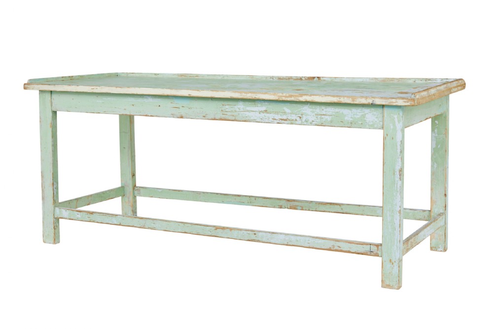 A 19th-century Swedish baking table featuring a pale green painted finish, a raised perimeter edge, and square legs connected by stretchers.