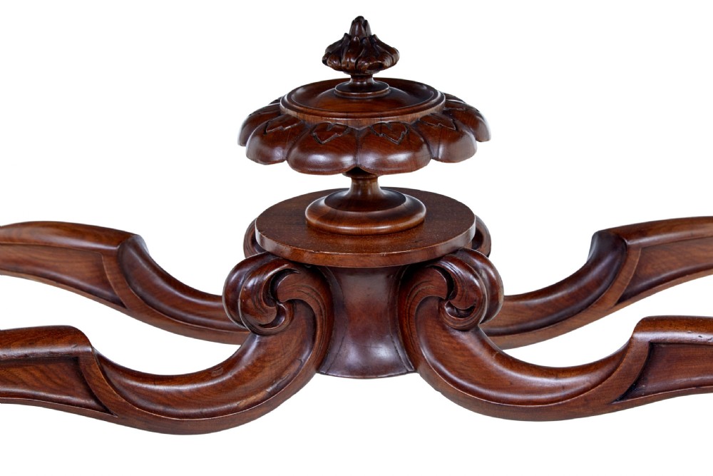 A 19th-century carved walnut occasional table featuring a shaped burr walnut top, ornate floral apron, cabriole legs, and a carved central stretcher finial on castors. View VIII