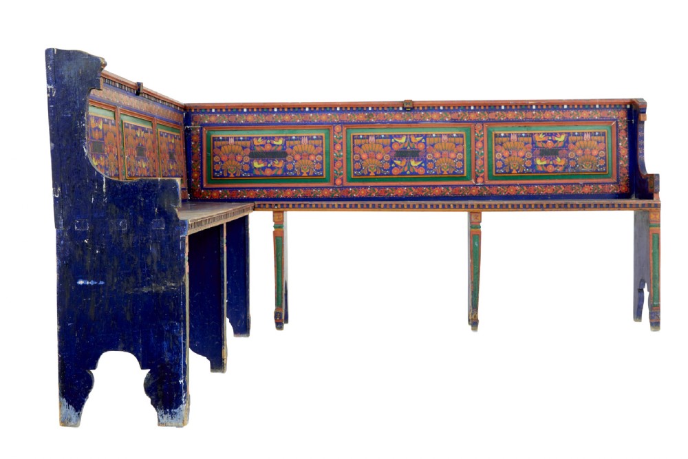 A nineteenth-century L-shaped wooden corner bench featuring hand-painted floral panels in red, green, and orange over a deep blue frame. View III