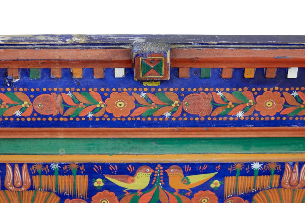 A nineteenth-century L-shaped wooden corner bench featuring hand-painted floral panels in red, green, and orange over a deep blue frame. View VIII