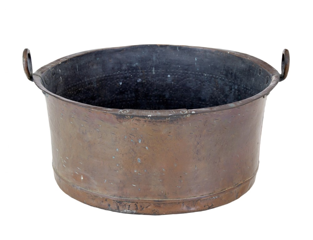 A large, circular nineteenth-century copper vessel with deep sides, hand-riveted seams, and two upright loop handles. View II