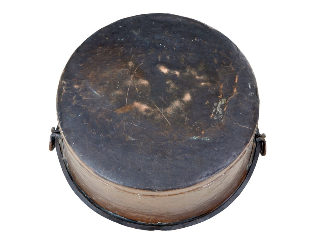 A large, circular nineteenth-century copper vessel with deep sides, hand-riveted seams, and two upright loop handles. View V