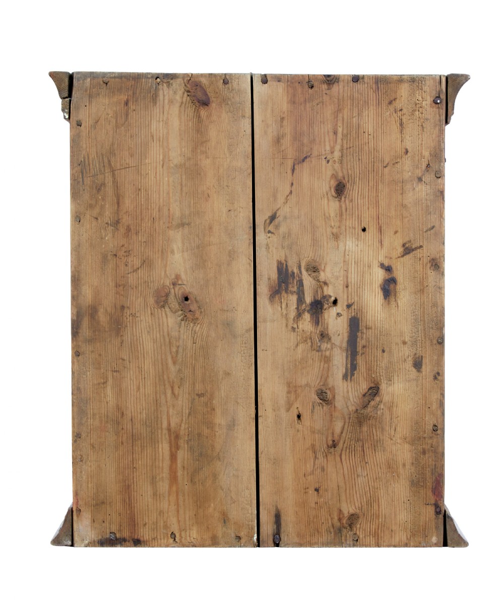 An early 19th-century Swedish painted pine wall cupboard featuring double panelled doors in a terracotta finish with moulded borders and central iron lock plate. View III