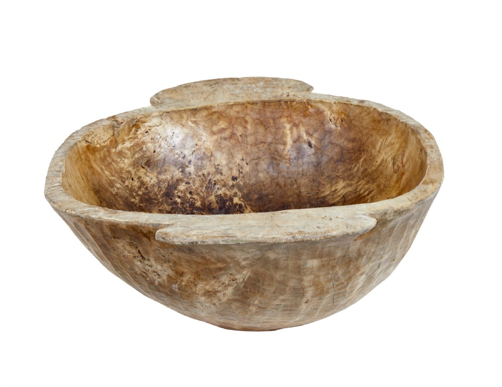 A large hand-carved rustic wooden bowl featuring side handles, hand-hewn tool marks, and natural timber grain. View II