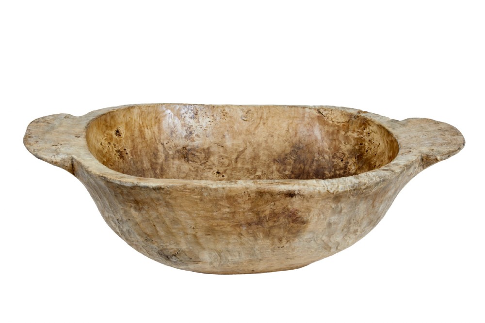A large hand-carved rustic wooden bowl featuring side handles, hand-hewn tool marks, and natural timber grain. View III