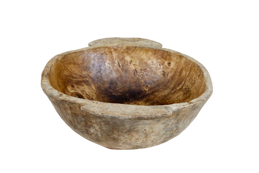 A large hand-carved rustic wooden bowl featuring side handles, hand-hewn tool marks, and natural timber grain. View IV