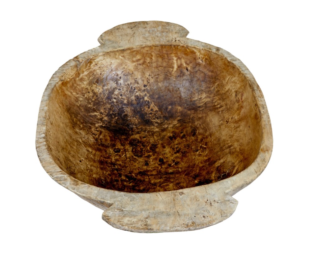 A large hand-carved rustic wooden bowl featuring side handles, hand-hewn tool marks, and natural timber grain. View VI