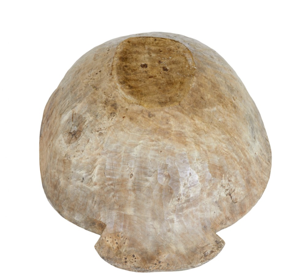 A large hand-carved rustic wooden bowl featuring side handles, hand-hewn tool marks, and natural timber grain. View VII