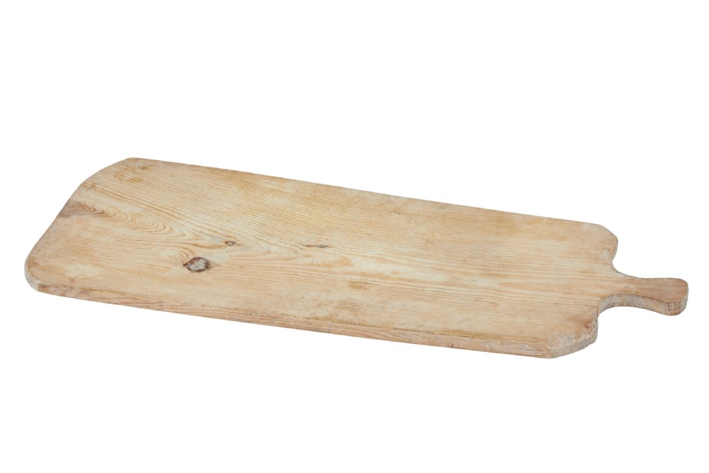A long rectangular pale pine breadboard featuring a shaped handle at one end and natural timber grain with a knot.