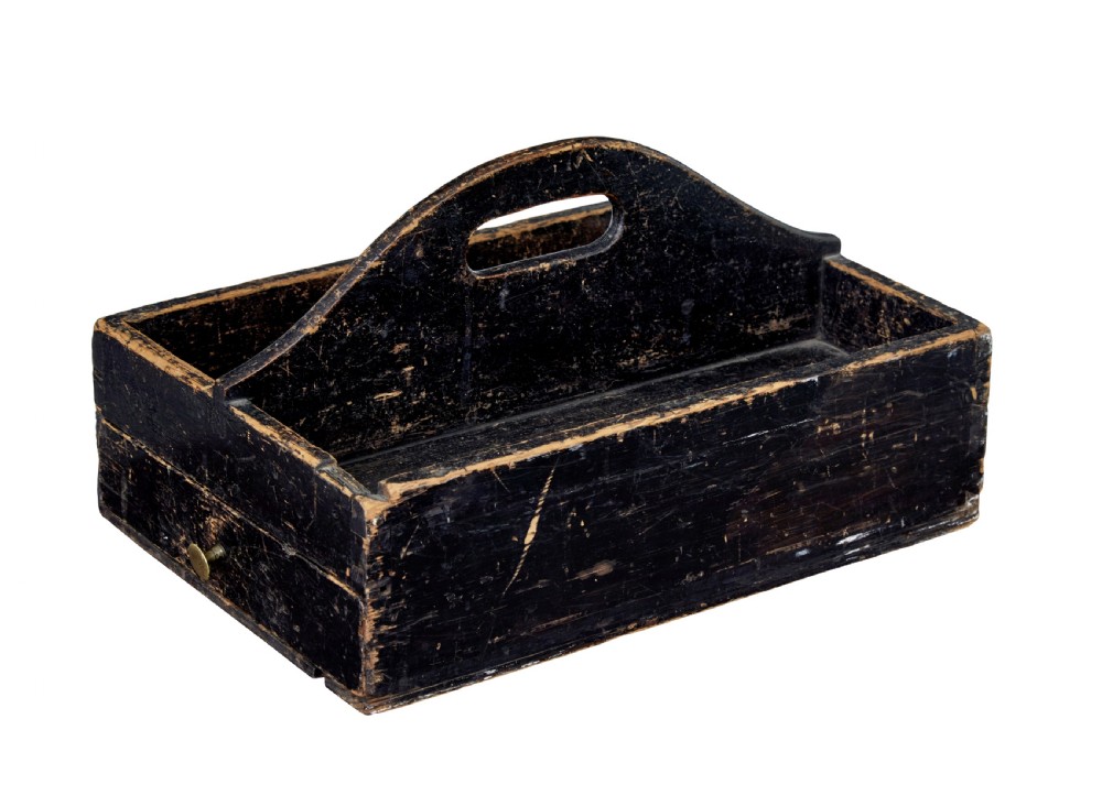 A 19th-century black-painted pine cutlery box featuring a central cut-out carrying handle and two divided compartments.