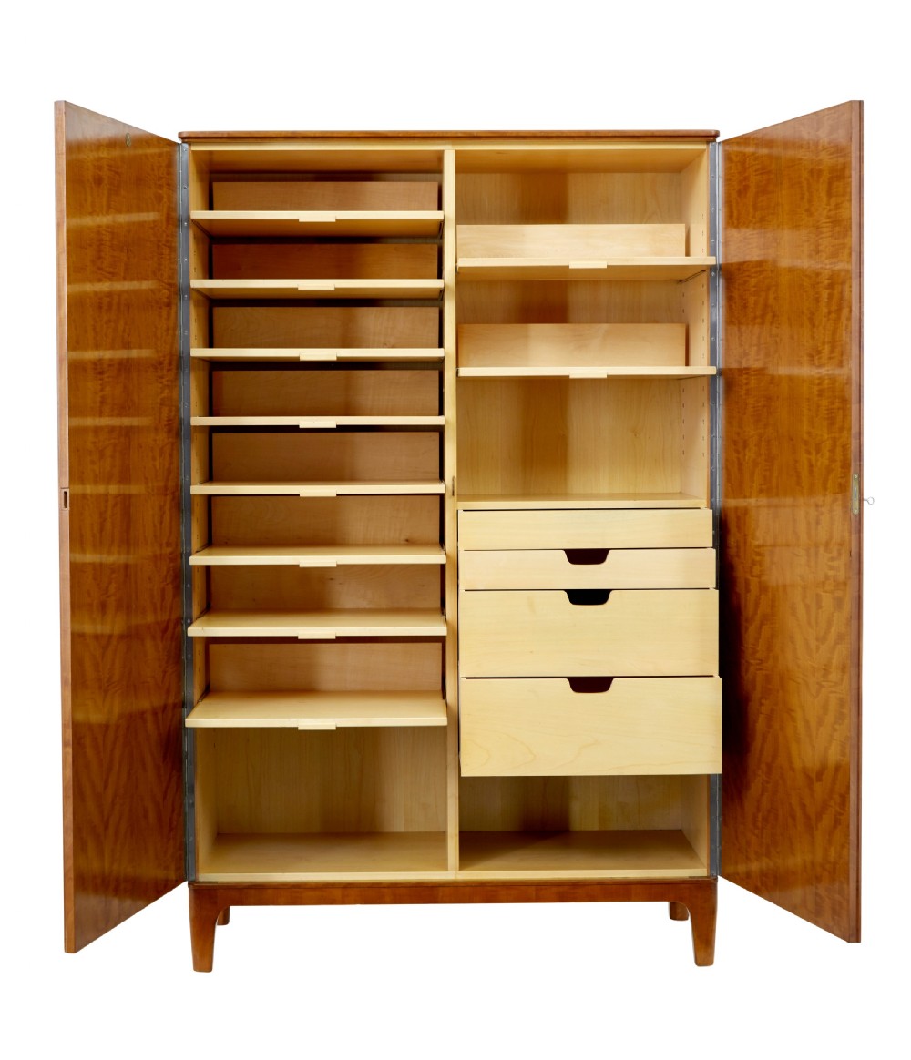 A mid-century modern double-door wardrobe crafted from figured golden birch wood with short tapered legs. View IV