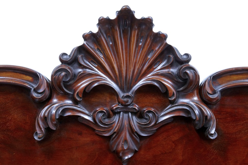 A 19th-century William IV mahogany sideboard featuring a carved anthemion splashback, four panelled cupboard doors, and a breakfront pedestal base. View VI