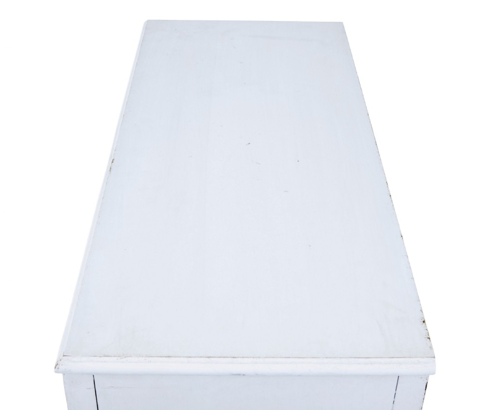 A 19th-century Swedish two-door cupboard painted in off-white, featuring simple panelled doors and small brass knobs. View VII