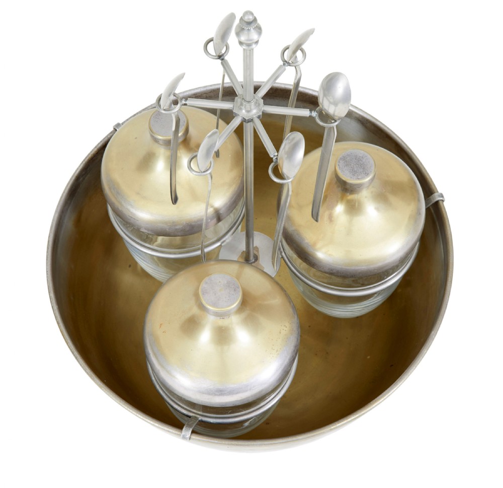 An early 20th-century Scandinavian metal and glass caviar ice server set featuring a central bowl, three lidded glass jars, and suspended spoons. View II