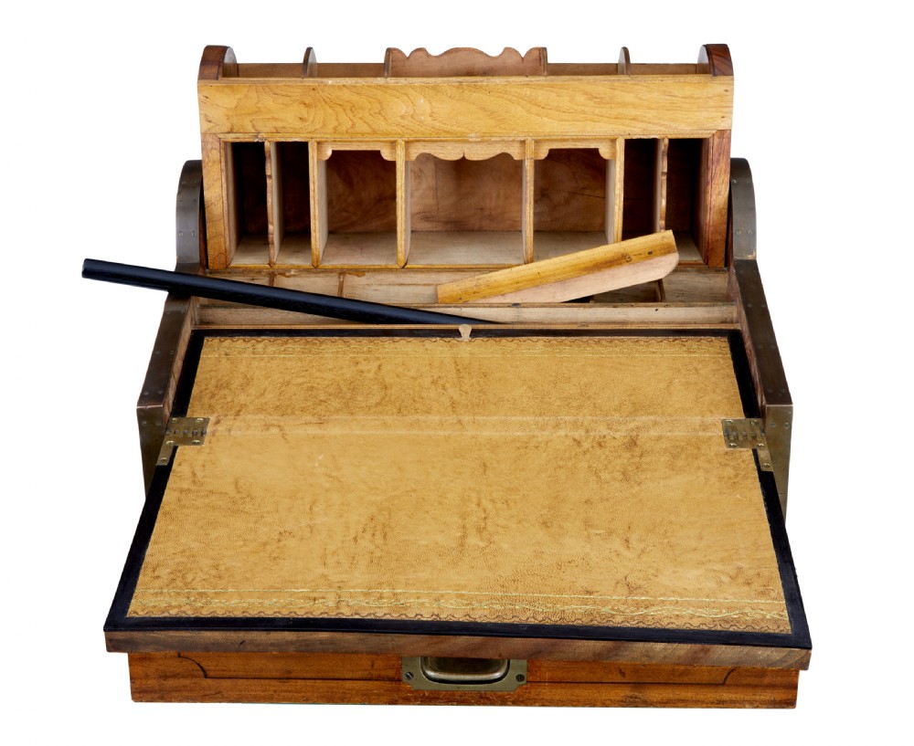 A mid-nineteenth century camphorwood campaign lap desk featuring a curved tambour roll top, sloped front, and recessed brass handles. View III