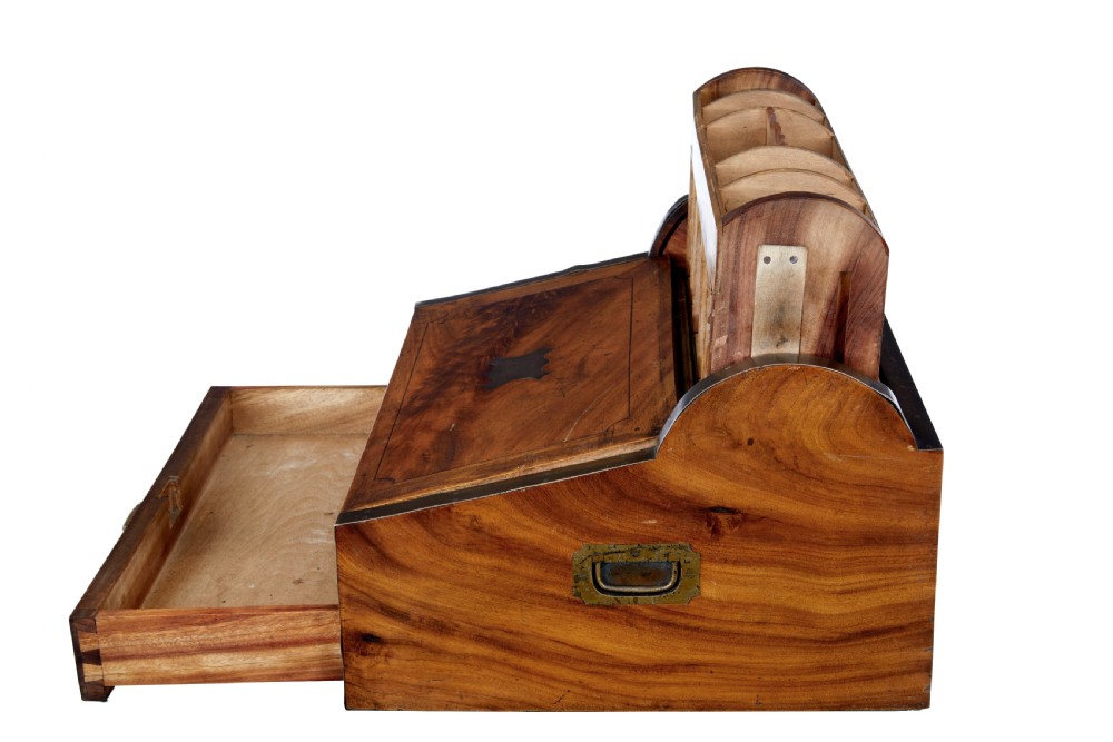 A mid-nineteenth century camphorwood campaign lap desk featuring a curved tambour roll top, sloped front, and recessed brass handles. View IV