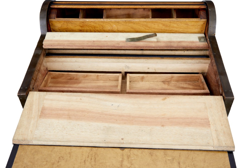 A mid-nineteenth century camphorwood campaign lap desk featuring a curved tambour roll top, sloped front, and recessed brass handles. View VII