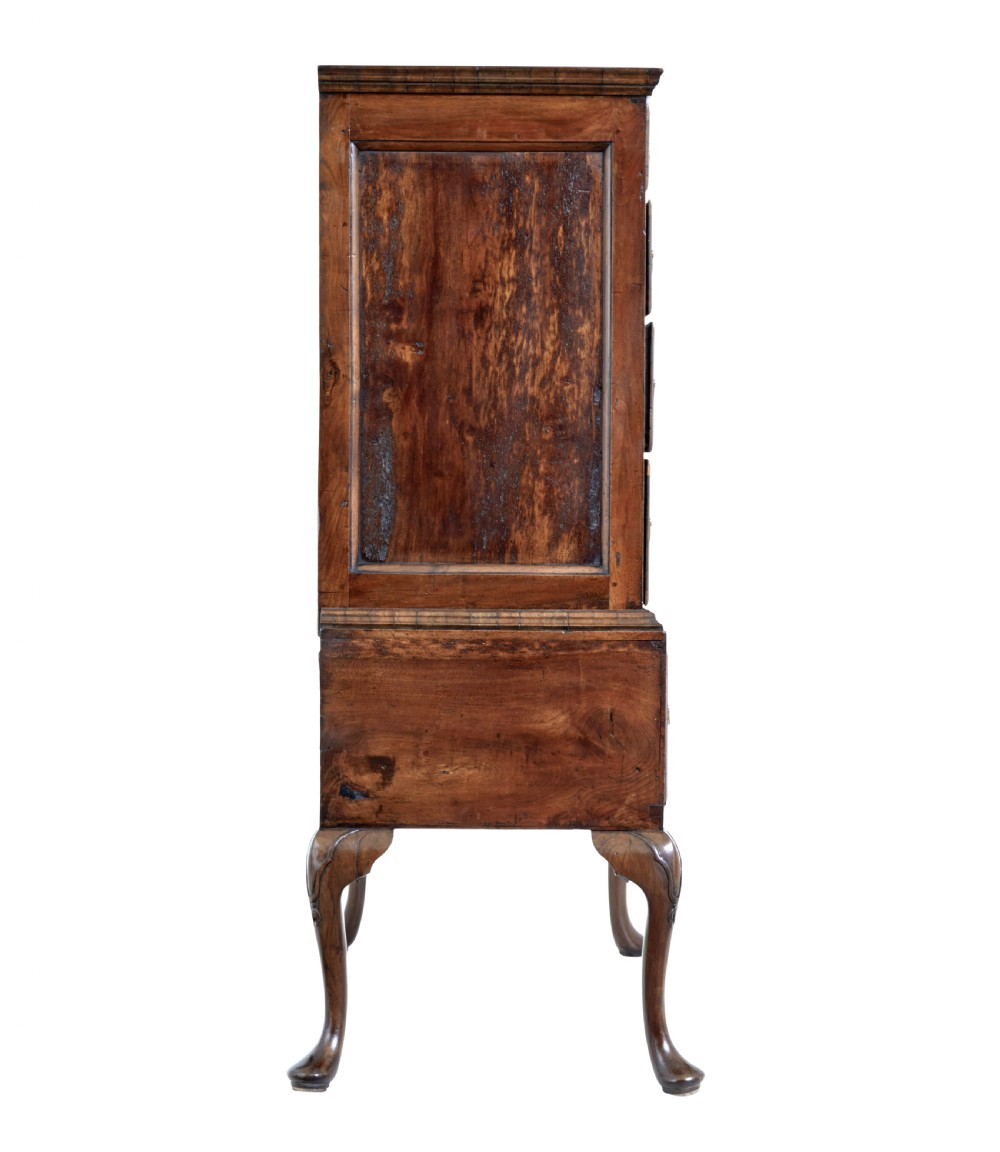 A late 17th-century William and Mary walnut chest on stand featuring five upper drawers, a single base drawer, decorative brass backplate handles, and cabriole legs. View VII