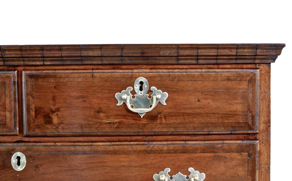 A late 17th-century William and Mary walnut chest on stand featuring five upper drawers, a single base drawer, decorative brass backplate handles, and cabriole legs. View VIII