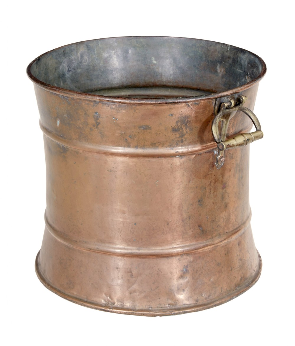 A cylindrical 19th-century copper vessel with horizontal ribbed banding and cast brass side handles.