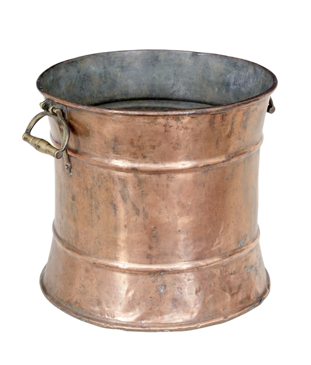 A cylindrical 19th-century copper vessel with horizontal ribbed banding and cast brass side handles. View II