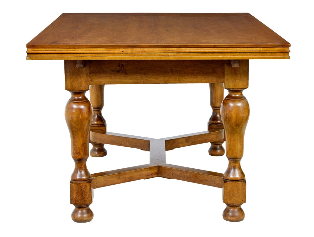An early 20th-century birch extending dining table with a rectangular top, turned baluster legs, and a low central stretcher base. View IV